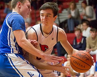 Canfield's Brayden Beck drives the ball while Lake's Tyson Blosser tries to block him during their game at Canfield High School on Tuesday night. EMILY MATTHEWS | THE VINDICATOR