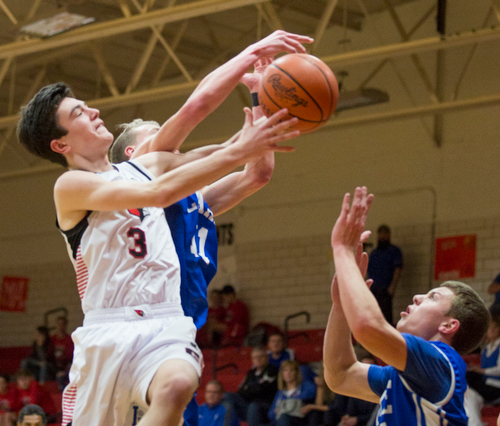 Canfield's Brayden Beck and Lake's Bryce Snow, left, and Tyson Blosser try to grab a rebound during their game at Canfield High School on Tuesday night. EMILY MATTHEWS | THE VINDICATOR