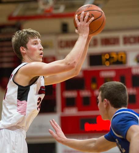 Canfield's Kyle Gamble looks to pass the ball while Lake's Tyson Blosser tries to block him during their game at Canfield High School on Tuesday night. EMILY MATTHEWS | THE VINDICATOR