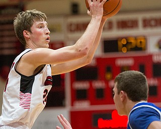 Canfield's Kyle Gamble looks to pass the ball while Lake's Tyson Blosser tries to block him during their game at Canfield High School on Tuesday night. EMILY MATTHEWS | THE VINDICATOR