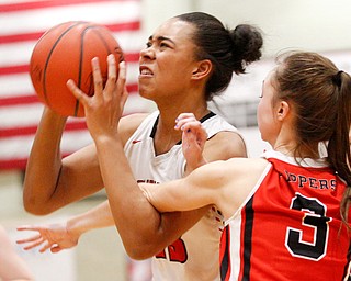 Struthers' Trinity McDowell looks to the hoop while Columbiana's Karissa Tringhese tries to block her during their game at Struthers on Wednesday night. EMILY MATTHEWS | THE VINDICATOR