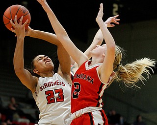 Struthers' Trinity McDowell tries to shoot after catching a rebound while Columbiana's Tori Long tries to block her during their game at Struthers on Wednesday night. EMILY MATTHEWS | THE VINDICATOR