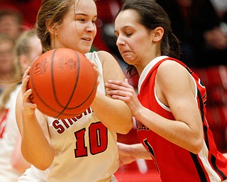 Struthers' Sabrina Bartholomew looks to pass the ball while Columbiana's Grace Hammond tries to block her during their game at Struthers on Wednesday night. EMILY MATTHEWS | THE VINDICATOR