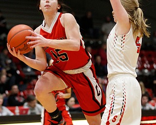 Columbiana's Kennedy Fullum looks toward the hoop while Struthers' Jessica Hughes tries to block her during their game at Struthers on Wednesday night. EMILY MATTHEWS | THE VINDICATOR