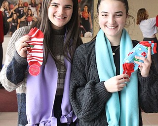Neighbors | Abby Slanker.Canfield High School seniors Lilly (left) and Cece Economus (right) collected socks and fleece to make scarves as their National  Honor Society community service project on Jan. 16. .