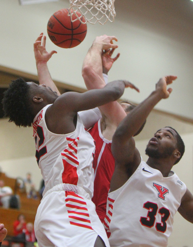William D. Lewis YSU's Garrett Covington(32) and NazBohannon(33) battle with IUPUI's Evan Hall(24) for a rebound) during 2-14-19 action at YSU.