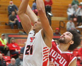 William D. Lewis YSU's Noe Anabir(21) drives around IUPUI's Ahmed Ismail(15) during 2-14-19 action at YSU.