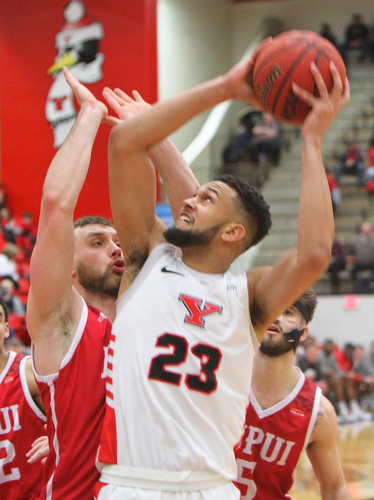 William D. Lewis YSU's Olemide Pedersen(23) shoots around IUPUI's Evan Hall (24) during 2-14-19 action at YSU.