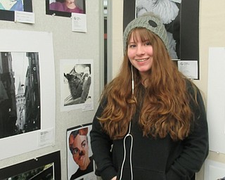 Neighbors | Jessica Harker .Kenzie Ligore, a sophomore at Boardman High School, posed next to her art that is on display at the Boardman library Feb. 5.