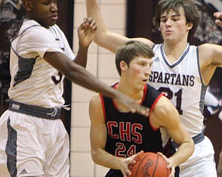 William D. Lewis The Vindicator  Canfield's Kyle Gamble(24) is hemmed in by Boardman's Derrick Anderson(3) and Cam Krep(21) during 2-15-19 action at Boardman.