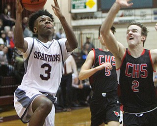 William D. Lewis The Vindicator   Boardman's Derrick Anderson(3) drives pat Canfield's Brent Herrmann(5)) during 2-15-19 action at Boardman.