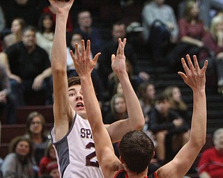 William D. Lewis The Vindicator  Boardman's Ethan Andersen(25) shoots over Canfield's Joe Bruno(5) during 2-15-19 action at Boardman.