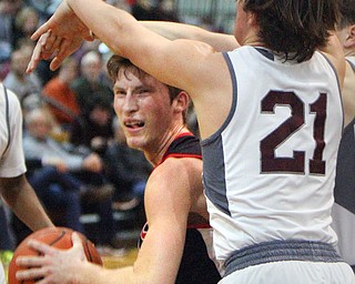 William D. Lewis The VindicatorCanfield's Kyle Gamble is hemmed in by Boardman'sCam Krps(21)during 2-15-19 action at Boardman.