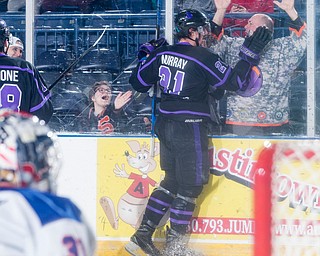 Scott R. Galvin | The Vindicator.Youngstown Phantoms forward Brett Murray (21) celebrates his second goal with a fan during the second period against Team USA NTDP goalie Noah Grannan (31) at the Covelli Centre on Saturday, February 15, 2019.