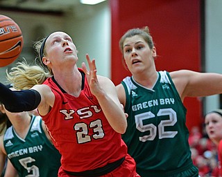 YOUNGSTOWN, OHIO - FEBRUARY 15, 2019: Youngstown State's Sarah Cash grabs a rebound away from Green Bay's Madison Wolf during the first half of their game, Friday night at Beeghly Center. DAVID DERMER | THE VINDICATOR