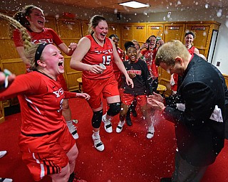 YOUNGSTOWN, OHIO - FEBRUARY 15, 2019: Youngstown State head coach John Barnes gets splashed in the locker room by McKenah Peters, Chelsea Olson and Mary Dunn after defeating Green Bay 70-59, Friday night at Beeghly Center. DAVID DERMER | THE VINDICATOR