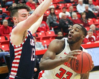 William D. Lewis The Vindicator YSU's Naz Bohannon(33) looks to pass around UIC's Jordan Blount(13) during 2-16-19 action at YSU.