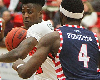 William D. Lewis The Vindicator YSU's Donel CathcartJr(13) looks to pass around UIC's Tarkus Ferguson(4) during 2-16-19 action at YSU.