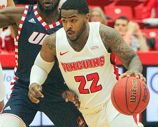 William D. Lewis The Vindicator YSU's Devin Morgan(22) drives around UIC's Marcus Ottey(1) during 2-16-19 action at YSU.