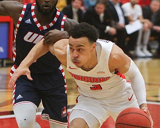 William D. Lewis The Vindicator YSU'sDarius Quisenberry(3 ) drives around UIC'sMarcus Ottey(1) during 2-16-19 action at YSU.