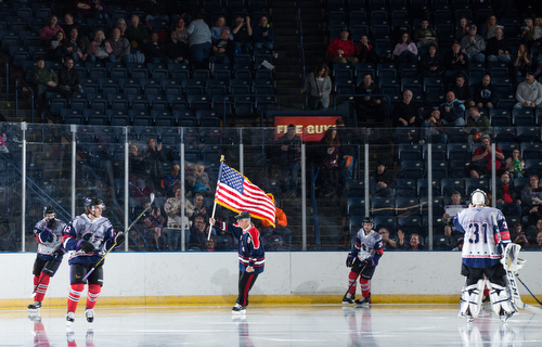 Scott R. Galvin | The Vindicator.Marine Corps. veteran Jim Rapone, from Warren, waves the flag as he escorts the Youngstown Phantoms onto the ice for the start of the second period against Team USA NTDP at the Covelli Centre on Saturday, February 16, 2019.