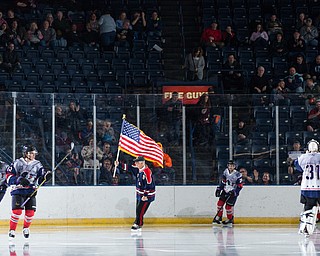 Scott R. Galvin | The Vindicator.Marine Corps. veteran Jim Rapone, from Warren, waves the flag as he escorts the Youngstown Phantoms onto the ice for the start of the second period against Team USA NTDP at the Covelli Centre on Saturday, February 16, 2019.