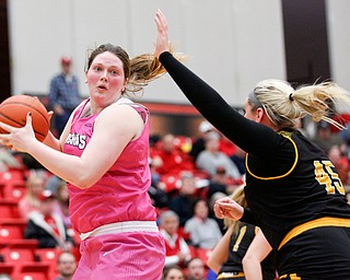 YSU's Mary Dunn looks to pass the ball while Milwaukee's Lizzie Odegard tries to block her during their game in Beeghly Center on Sunday afternoon. EMILY MATTHEWS | THE VINDICATOR