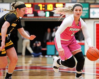 YSU's Alison Smolinski drives the ball while Milwaukee's Mckaela Schmelzer tries to block her during their game in Beeghly Center on Sunday afternoon. EMILY MATTHEWS | THE VINDICATOR