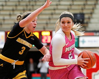 YSU's Alison Smolinski drives the ball while Milwaukee's Mckaela Schmelzer tries to block her during their game in Beeghly Center on Sunday afternoon. EMILY MATTHEWS | THE VINDICATOR