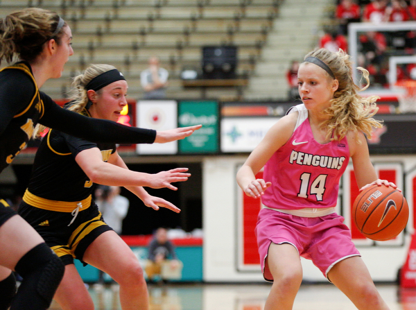 YSU's Melinda Trimmer drives the ball while Milwaukee's Megan Walstad, left, and Mckaela Schmelzer try to block her during their game in Beeghly Center on Sunday afternoon. EMILY MATTHEWS | THE VINDICATOR