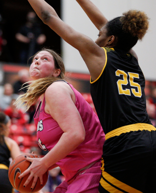 YSU's Mary Dunn looks toward the hoop while Milwaukee's Ryaen Johnson tries to block her during their game in Beeghly Center on Sunday afternoon. EMILY MATTHEWS | THE VINDICATOR