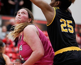 YSU's Mary Dunn looks toward the hoop while Milwaukee's Ryaen Johnson tries to block her during their game in Beeghly Center on Sunday afternoon. EMILY MATTHEWS | THE VINDICATOR