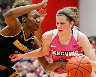 YSU's Chelsea Olson drives the ball while Milwaukee's Ryaen Johnson tries to block her during their game in Beeghly Center on Sunday afternoon. EMILY MATTHEWS | THE VINDICATOR