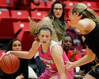 YSU's Chelsea Olson drives the ball while Milwaukee's Sydney Staver tries to block her during their game in Beeghly Center on Sunday afternoon. EMILY MATTHEWS | THE VINDICATOR