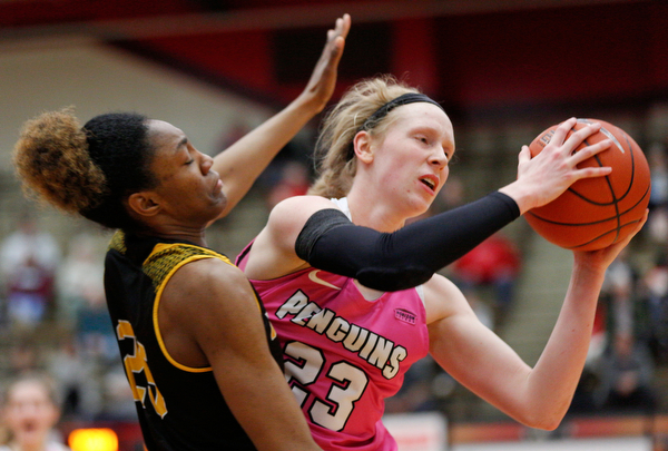 YSU's Sarah Cash tries to pass the ball while Milwaukee's Ryaen Johnson tries to block her during their game in Beeghly Center on Sunday afternoon. EMILY MATTHEWS | THE VINDICATOR