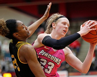 YSU's Sarah Cash tries to pass the ball while Milwaukee's Ryaen Johnson tries to block her during their game in Beeghly Center on Sunday afternoon. EMILY MATTHEWS | THE VINDICATOR