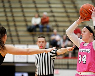 YSU's McKenah Peters looks to pass the ball while Milwaukee's Jamie Reit tries to block her during their game in Beeghly Center on Sunday afternoon. EMILY MATTHEWS | THE VINDICATOR