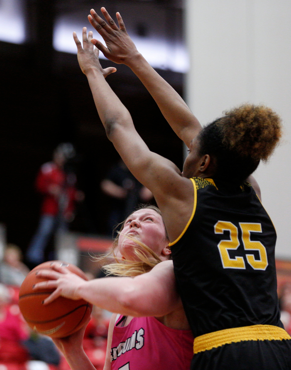 YSU's Mary Dunn looks toward the hoop while Milwaukee's Ryaen Johnson tries to block her during their game in Beeghly Center on Sunday afternoon. EMILY MATTHEWS | THE VINDICATOR