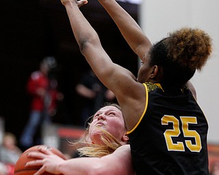 YSU's Mary Dunn looks toward the hoop while Milwaukee's Ryaen Johnson tries to block her during their game in Beeghly Center on Sunday afternoon. EMILY MATTHEWS | THE VINDICATOR