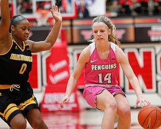 YSU's Melinda Trimmer drives the ball while Milwaukee's Alyssa Moore tries to block her during their game in Beeghly Center on Sunday afternoon. EMILY MATTHEWS | THE VINDICATOR