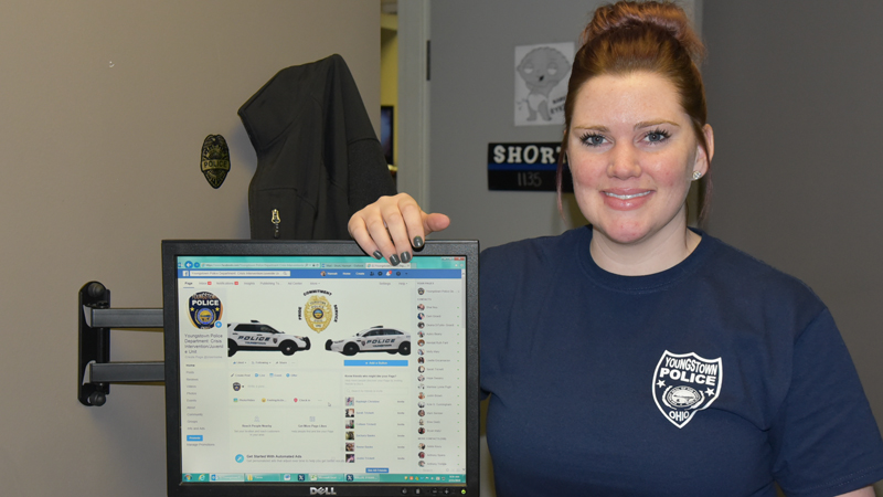 Youngstown police officer Hannah Short shows off the Facebook page for the department’s Crisis Intervention/Juvenile Unit. 