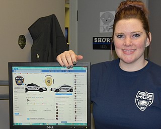 Youngstown police officer Hannah Short shows off the Facebook page for the department’s Crisis Intervention/Juvenile Unit. 