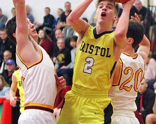 William D. Lewis The Vindicator  Bristols Gage elza(2) drives to the hoop past Mooney's Antony fire(11) and Matt Brennan(20).