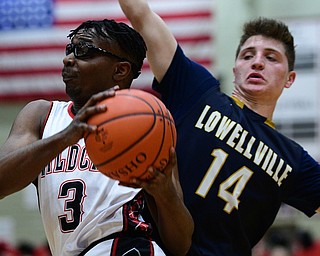 STRUTHERS, OHIO - FEBRUARY 19, 2019: Struthers' Kevin Traylor drives on Lowellville's Matt Hvisdak  during the first half of their game, Tuesday night at Struthers High School. Lowellville won 55-48. DAVID DERMER I THE VINDICATOR