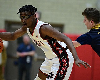 STRUTHERS, OHIO - FEBRUARY 19, 2019: Struthers' Kevin Traylor spins away from Lowellville's Matt Hvisdak during the first half of their game, Tuesday night at Struthers High School. Lowellville won 55-48. DAVID DERMER I THE VINDICATOR