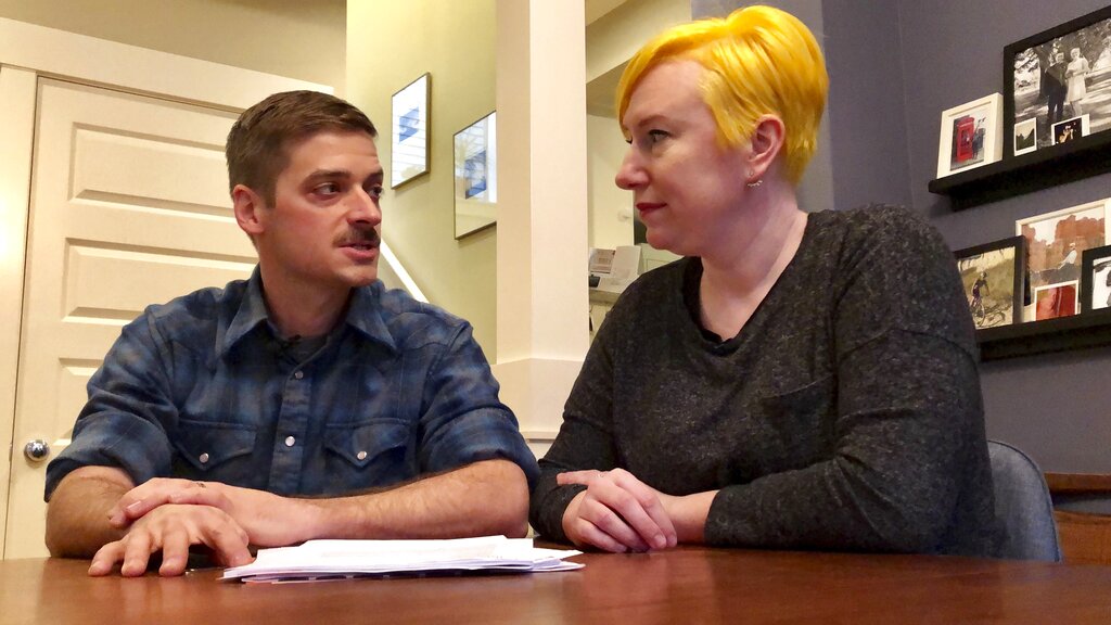 Husband and wife Andy Kraft and Amy Elias, of Portland, Ore., talk during an interview about their 2018 tax paperwork in their home Monday, Feb. 18, 2019. The couple got a small refund last year but this year owe more than $10,000 in taxes under the new tax law.