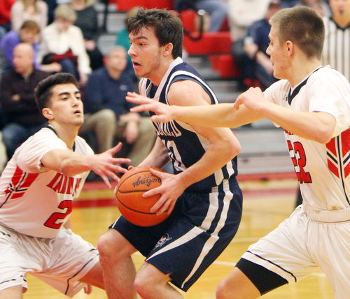 William D. Lewis The Vindictor  McDonald's Josh Celli(10) drives between Giard's Austin Claussell(2) and Christian Graziano(22) during 2-20-19 action at Girard.