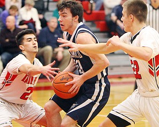 William D. Lewis The Vindictor  McDonald's Josh Celli(10) drives between Giard's Austin Claussell(2) and Christian Graziano(22) during 2-20-19 action at Girard.