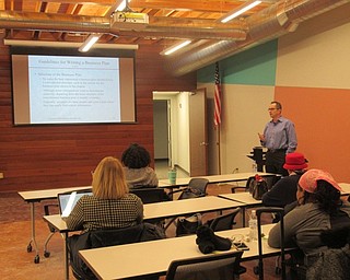 Neighbors | Jessica Harker.Joseph Angelo, director of YSU Entrepreneurship Center, addressed community members at the Michael Kusalaba library on Jan. 31.