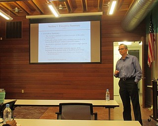 Neighbors | Jessica Harker .Youngstown State University Director of Entrepreneurship Center Joseph Angelo discussed the best ways to create a business plan on Jan. 31 at the Michael Kusalaba library.